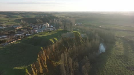 Aerial-drone-fly-Cea-Castle-Leon-Spain-historical-architecture-landscape-travel-spanish-town-around-rural-meadows,-sunrise-skyline-background