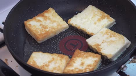 pieces of cheese frying on a pan