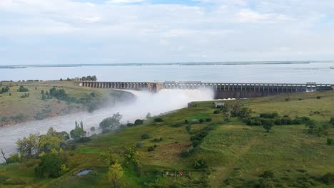 Reservoir-Dam-Sluice-Gates-Overflowing-with-Lake-Behind-It-,-Drone-Shot,-Vaaldam-South-Africa