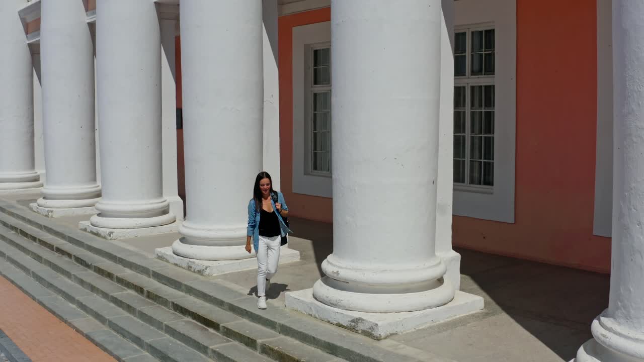 Beautiful woman near column. Young woman near ancient column