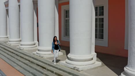 beautiful woman near column. young woman near ancient column