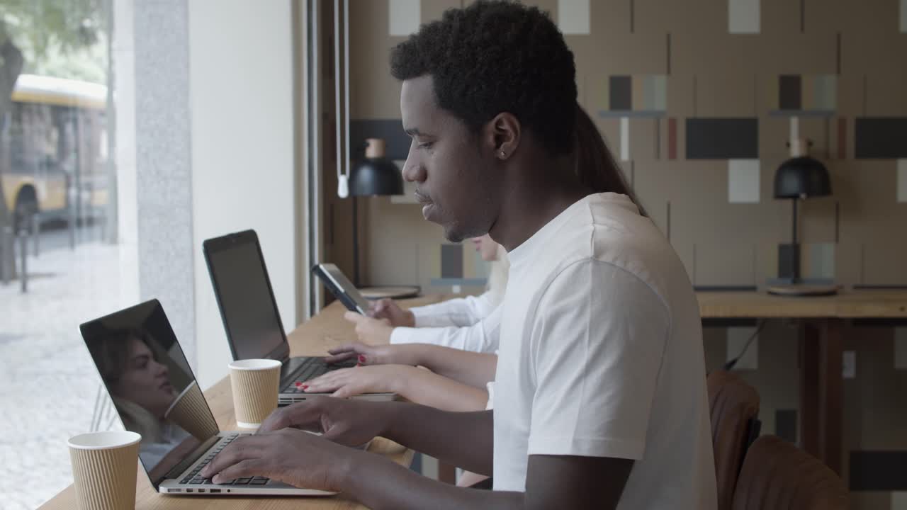 Serious African American professional sitting at counter