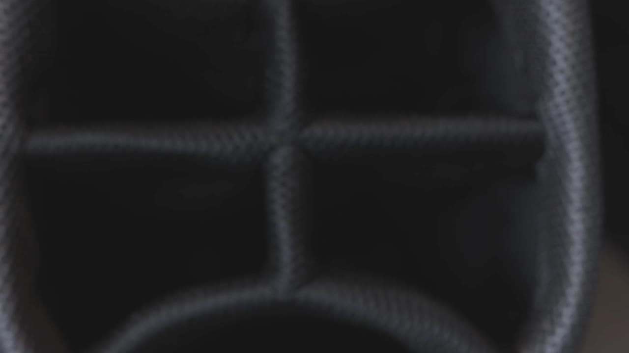 Close up of a 9 iron being taken out of a golf bag