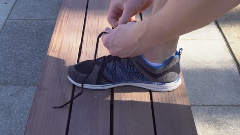 a runner is tying his shoes