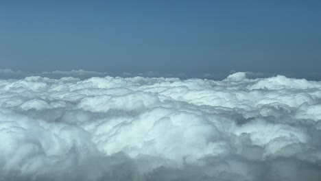 Aerial-cloudscape-while-flying-above-la-blanket-of-clouds