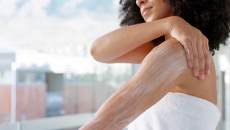 Black-woman,-body-cream-and-skincare-in-a-bathroom