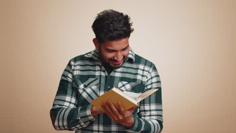 happy hindu man reading funny interesting fairytale story book leisure hobby education learning