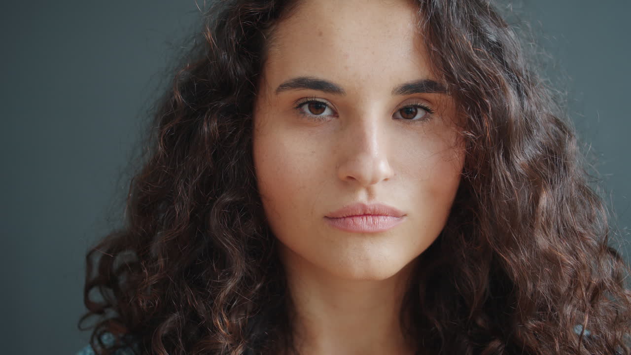 Close-up portrait of a woman with curly brown hair
