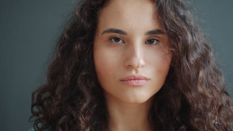 close-up portrait of a woman with curly brown hair