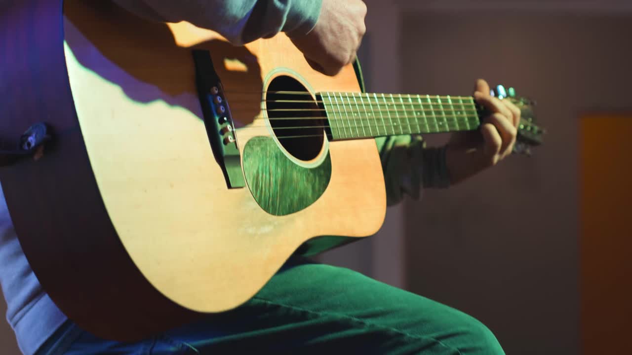 Close-up of a Person Playing Acoustic Guitar