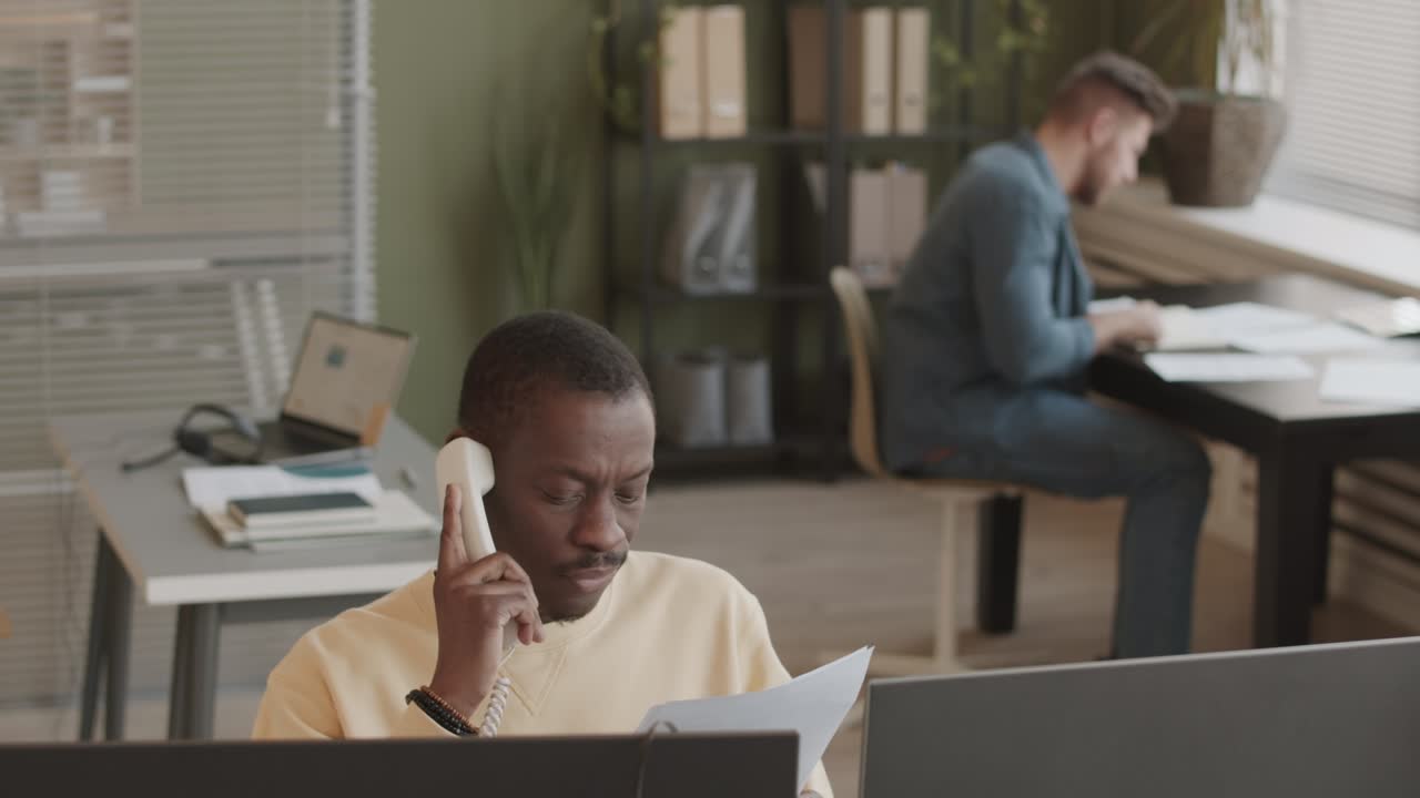 African American Stock Trader Talking to Client