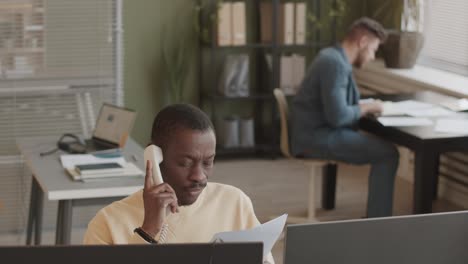 african american stock trader talking to client