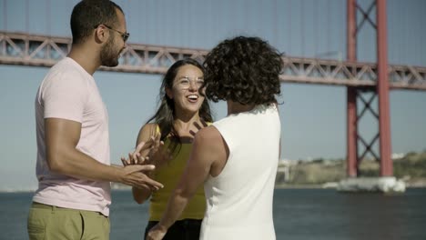 happy young friends near river