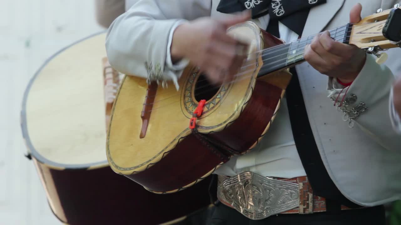 Close up of a mexican mariachi playing a Vihuela string musical instrument