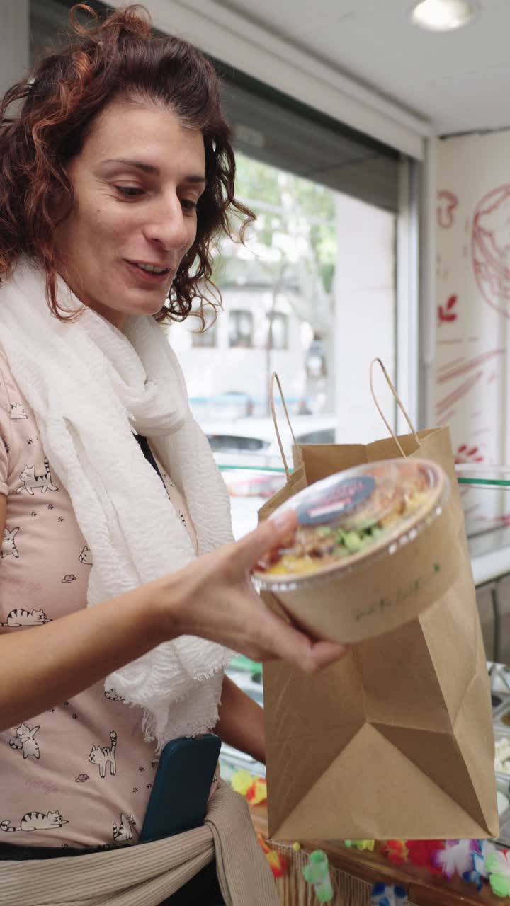 Images of women at a Poke Bowl restaurant taking orders and handing out a shopping bag