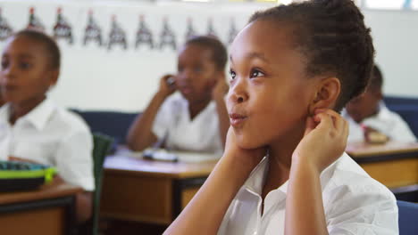 Schoolgirl-listening-during-a-lesson-at-an-elementary-school