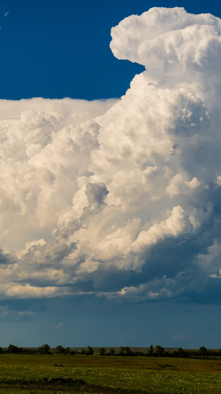 Calm evening sky with building storm clouds movement through warm glowing light