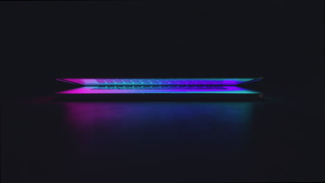 a macbook pro lighting up in the dark reminding us about the future that is to come