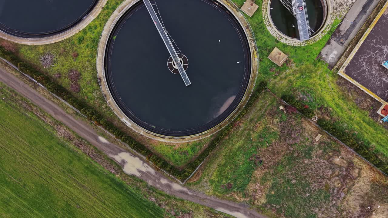 Water purification plant in operation with circular tanks and pathways