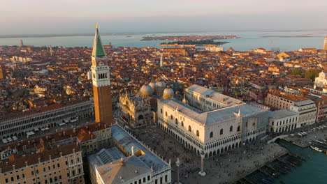 people at piazza san marco with the famous st mark's campanile in venice, italy