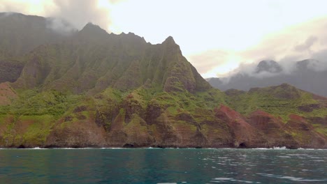 4k hawaii kauai boating on ocean floating left to right from mountain shoreline to na pali coast state wilderness park