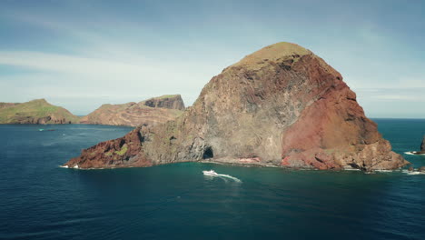 aerial at ponta do furado, steep cliffs of madeira shore with boat