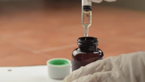 measuring dosage of medication with syringe close up shot