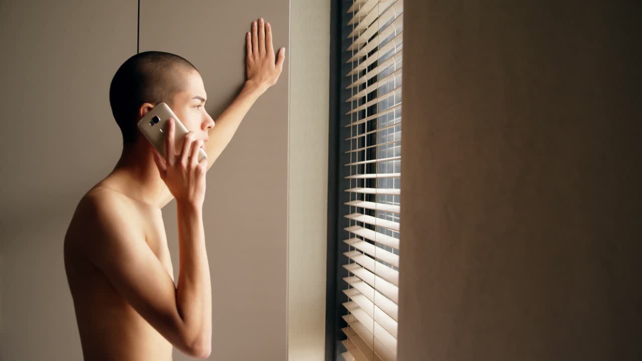hombre hablando por teléfono móvil en casa 4k