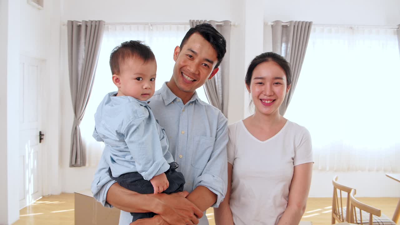Asian Family Smiling In House