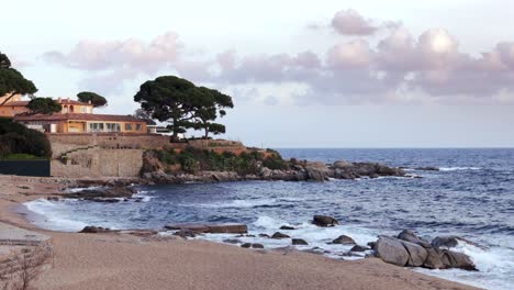 picturesque island and person walking sandy beach under cloudy sky