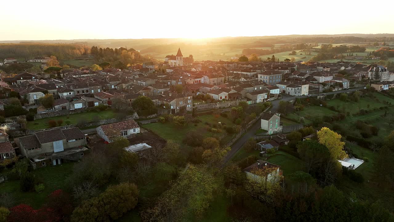 Sunset over the bastide town of Monpazier, aerial view by drone, the sun's rays illuminate the sleepy little town, Dordogne, France