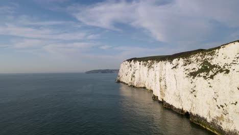 Aerial-forward-ascending-along-white-wall-of-Old-Harry-Rocks-cliff,-Dorset-in-England