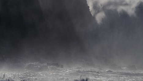 huge ocean waves roll and crash into a rocky shore in slow motion 2