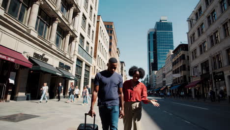 couple on a city trip with luggage and map