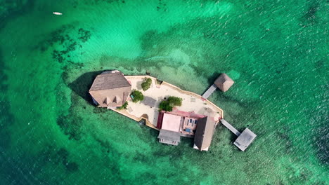 bird's eye view of lodge island in caribbean sea colombia, turquoise swallow transparent water