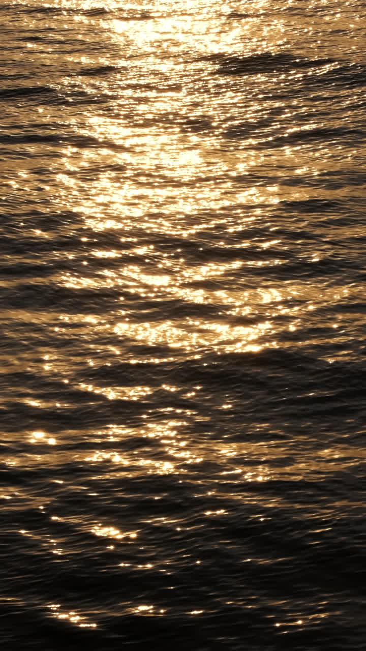 Slow motion of blurred sea surface at sunset. Calm soothing waters