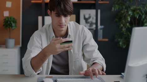 man using credit card for online purchase
