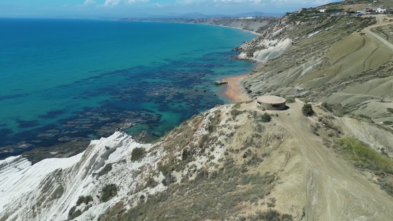 Aerial drone footage of Punta Bianca, Sicily: white limestone cliffs, turquoise sea, and untouched coastline. Perfect for travel, nature, and cinematic landscape projects