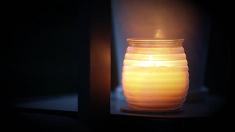 perfect candle flicking in white fogged out jar