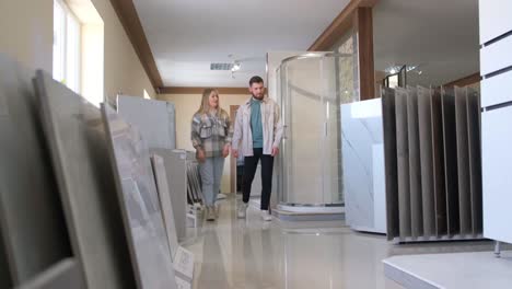 couple choosing tiles in a showroom