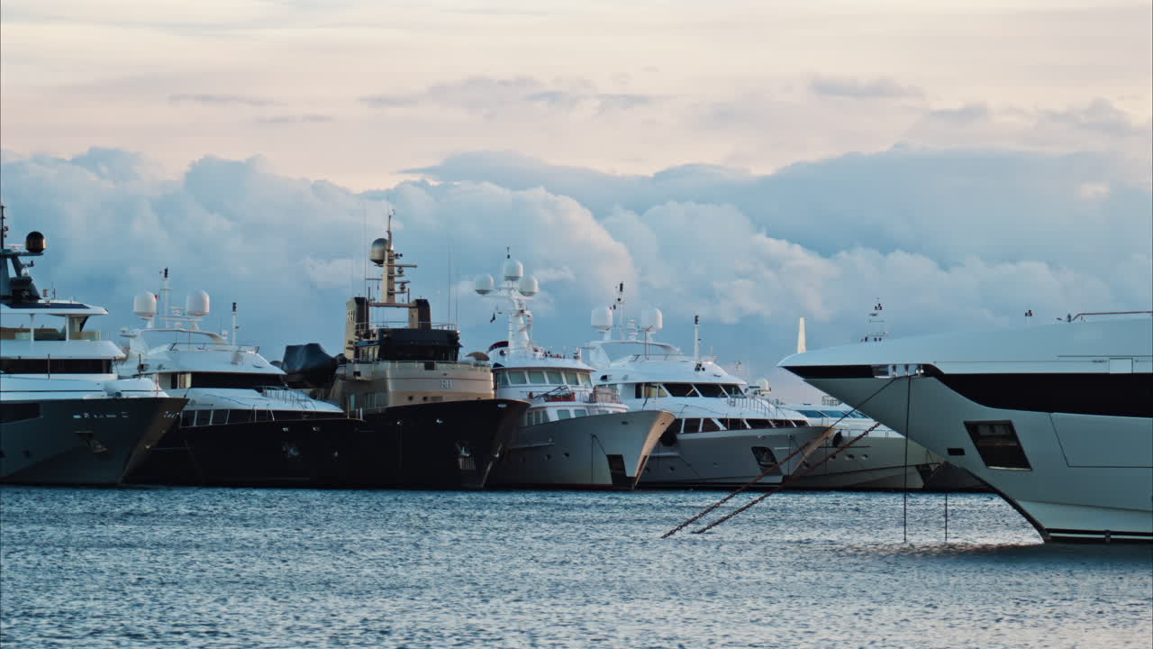 Nice, France - January 10, 2025: Boats docked in the Port of Nice with the clouds on the background
