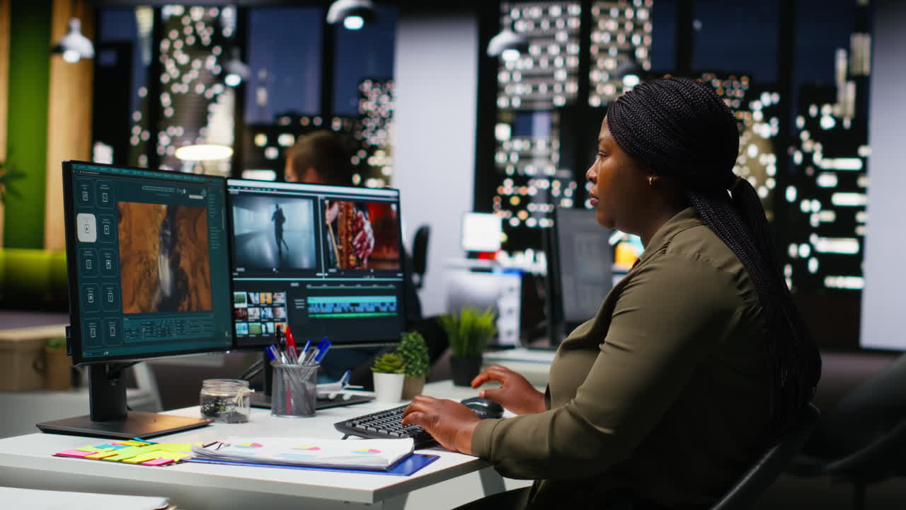 Female specialist editor working in video production industry at agency office