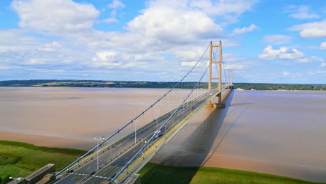 A-stunning-aerial-drone-video-of-the-Humber-Bridge—the-12th-largest-single-span-suspension-bridge-globally—revealing-the-River-Humber-and-bustling-traffic,-connecting-Lincolnshire-to-Humberside