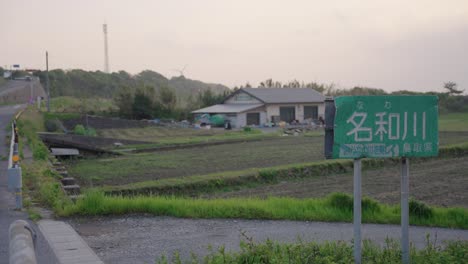 nawa river sign with farmlands of daisen, tottori in the background