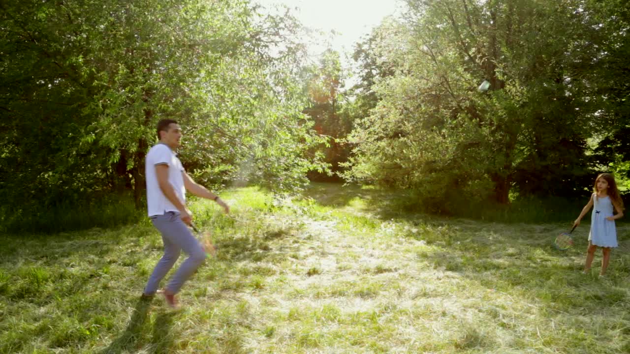 Father and Daughter Playing Badminton in the Park
