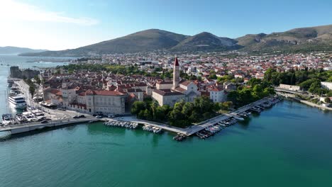 aerial establishing overview of trogir stunning coastal landscape, with boats in the harbor and historic town center on sunny day