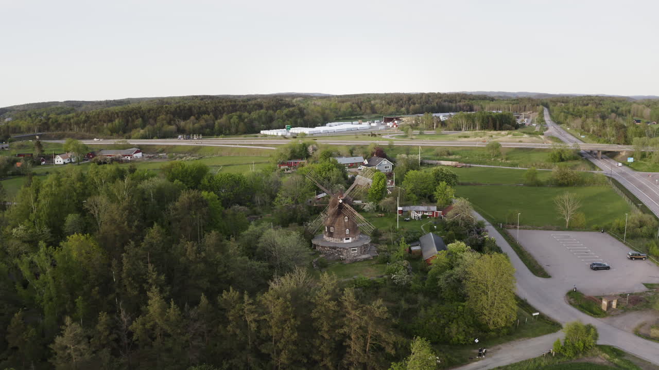 Wide aerial Drone shot flying in towards Sunvära kvarn Museum and windmill in Sweden.