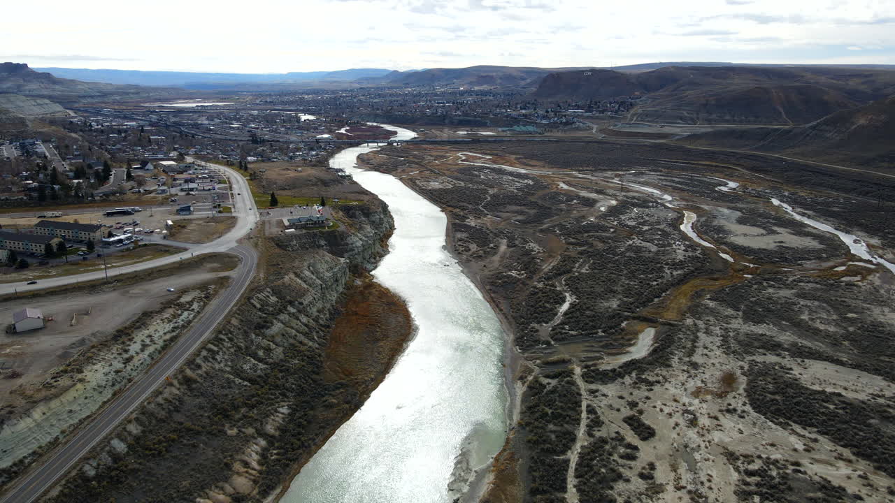 Aerial View of a River Running Through a Town in a Mountain Valley