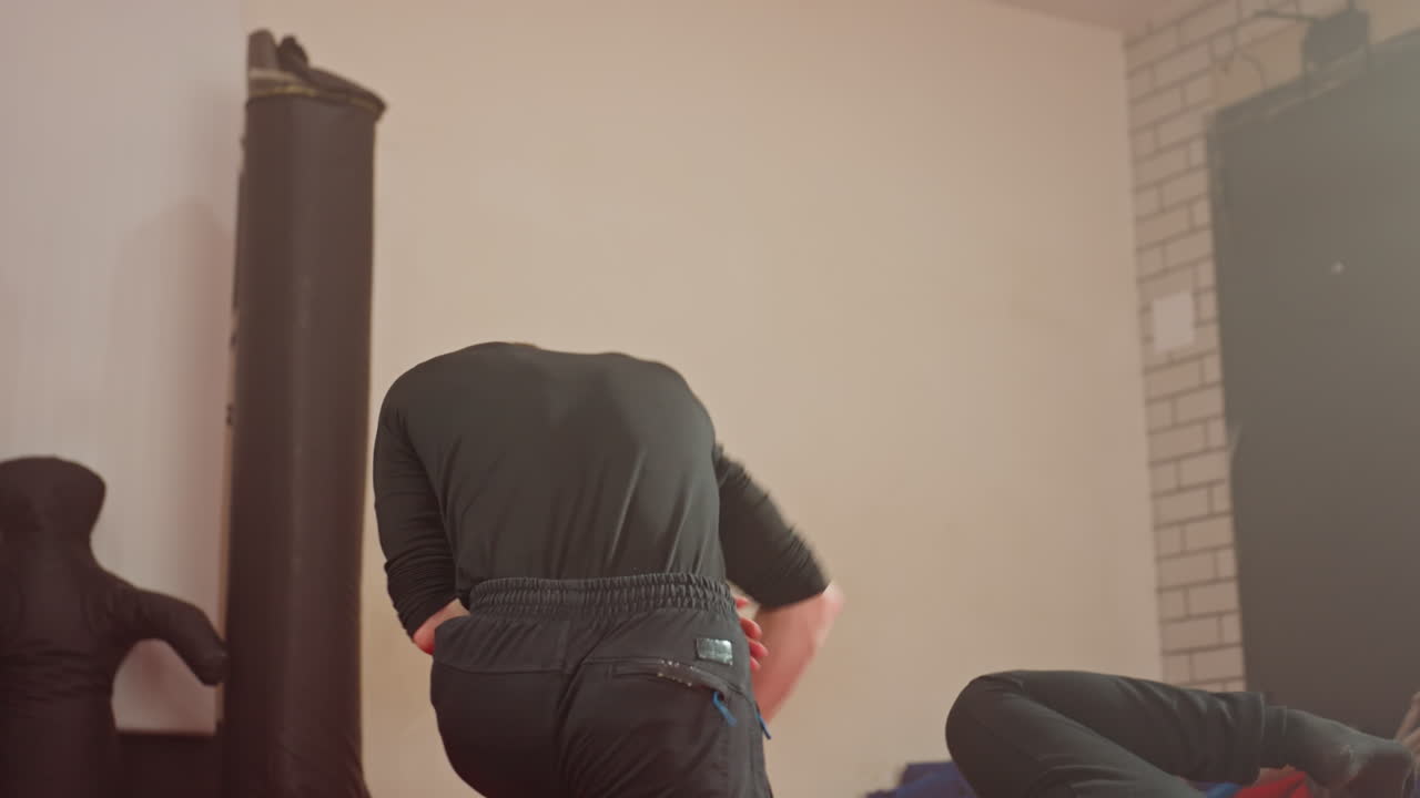 Wrestlers face off inside gym during sparring training session, grapple in combat stance, showing intensity, focus, strength, and determination while practicing competitive fighting techniques