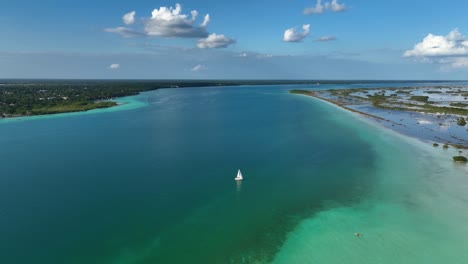 aerial view of a sailboat at the bacalar lagoon, sunny quintana roo, mexico